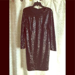 Long sleeved black sequin dress.